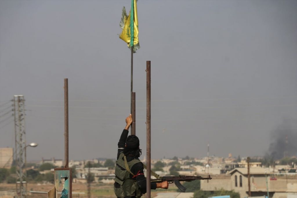 جنود الجيش الوطني السوري ينزلون أعلام الوحدات الكردية من قرية تل حلف بعد السيطرة عليها "ًصور" 1